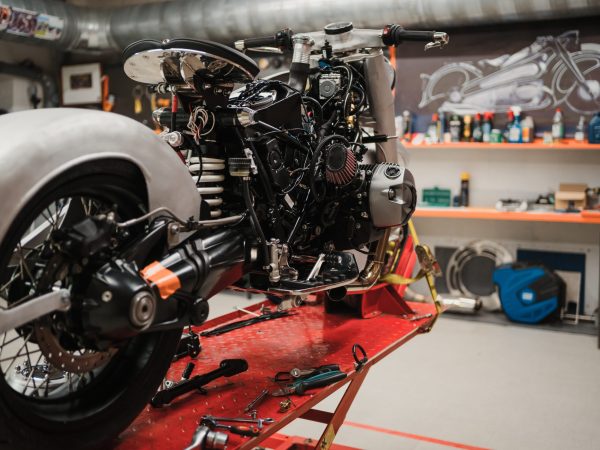 Fixing Custom motorcycle standing in repair shop. Instruments and equipment. Hobbies and unique Jobs